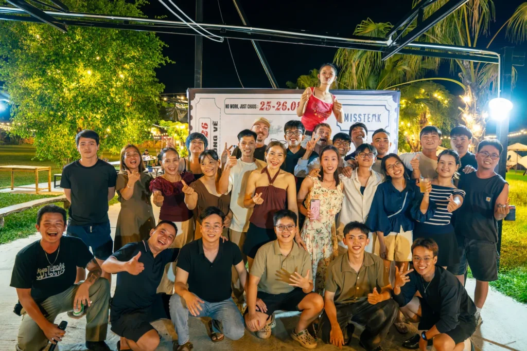 The Missteak team gathered together outside at night, in front of the restaurant's banner